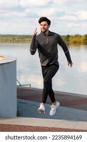 Running and Jogging Concepts. Handsome Caucasian Brunette Man Runner Running Upstairs Near River.Vertical Orientation - Shutterstock ID 2235894169
