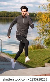 Running and Jogging Concepts. Handsome Caucasian Brunette Man Runner Running Upstairs on Bridge Near River Bank.Vertical Shot - Shutterstock ID 2235928265