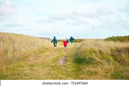 Running Kids Children In Denmark In The Dunes Near The Beach In Blåvand Travelling Holiday In Scandinavia