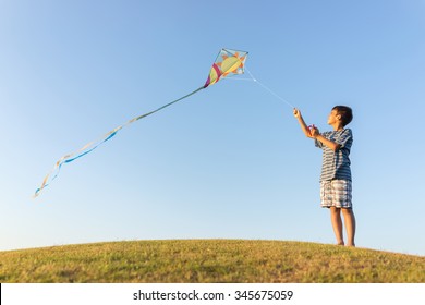 Running with kite on summer holiday vacation, perfect meadow and sky on seaside