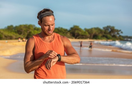 Running Man Athlete Using Smartwatch Fitness App On Wearable Tech Device Smart Sports Watch Training On Beach. Runner Working Out Sweating On Summer Day Banner.