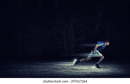 Running Man In Blue Sport Wear On Black Background