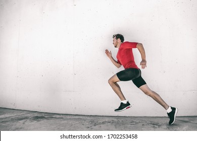 Running Man Fit Athlete Male Runner Working Out Outside Doing City Street Run Sprinting Along Gym Wall. Sprinter Going Fast Living Active Lifestyle Doing Sprint Hiit High Intensity Interval Training.