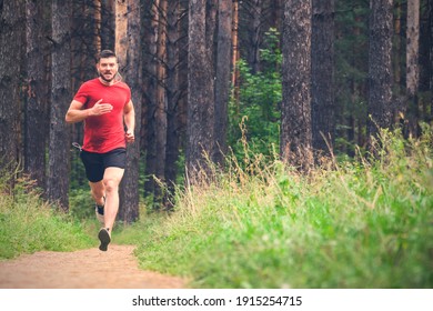 Running Man. Male Runner Jogging At The Park. Guy Training Outdoors. Exercising On Forest Path. Healthy, Fitness, Wellness Lifestyle. Sport, Cardio, Workout Concept