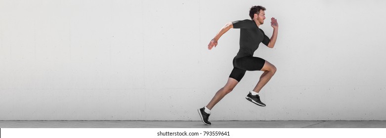 Running man runner training doing outdoor city run sprinting along wall background. Urban healthy active lifestyle. Male athlete doing sprint hiit high intensity interval training. Banner panorama.