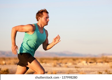 Running Man Sprinting Cross Country Trail Run. Male Fit Sport Fitness Model Training For Marathon Outside In Beautiful Landscape. Caucasian Handsome Guy In His 20s.