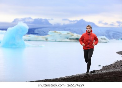 Running Man. Trail Runner Training For Marathon Run In Beautiful Nature Landscape. Fit Male Athlete Jogging And Cross Country Running By Icebergs In Jokulsarlon Glacial Lake In Iceland.