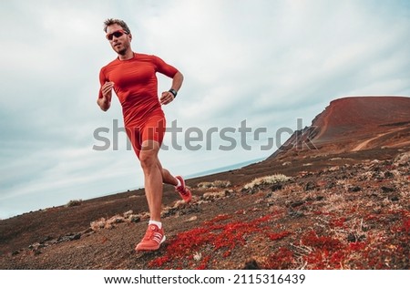 Running marathon man runner sport athlete training ultra running on long distance endurance trail race wearing compression clothes, sunglasses smartwatch wearable device.