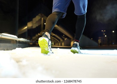 Running At Night.
Running In The Winter At Night, Runner's Shoes In The Snow.
