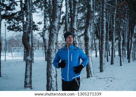 Similar – Young man running outdoors during workout in a forest