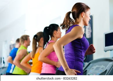 Running On Treadmill In Gym Or Fitness Club - Group Of Women And Men Exercising To Gain More Fitness