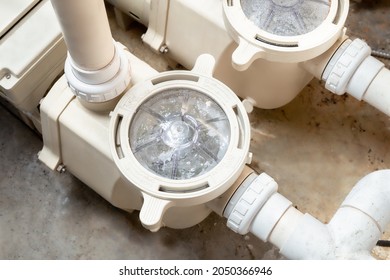 Running Pool Pump System, Inside. Perspective View Of Two Installed Pool Pumps With Connected Pipes. Used To Filter And Circulate Water For A Standard Pool Or Inground Pool. Selective Focus.