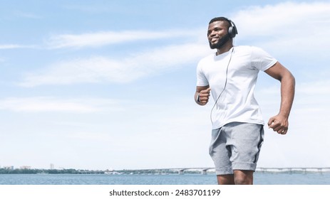 Running Routine. Afro Man Jogging Outdoor Near River In Morning. Free Space, Panorama - Powered by Shutterstock