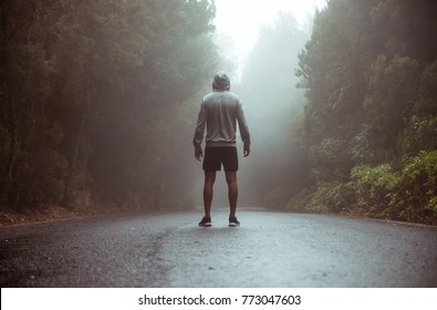 Running runner man sprinting workout on mountain road