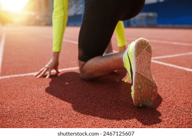 Running shoe of athletic runner training in stadium at sunset, preparing for sports competition, Summer Olympic games in Paris, France