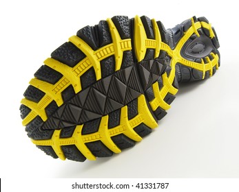 Running Shoe With Yellow And Black Tread Pattern On White