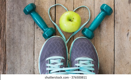 Running shoes and dumbbell fitness on wooden background, Healthy sport and shoes couple concept.