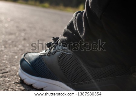 running shoes on the pavement during the morning jog