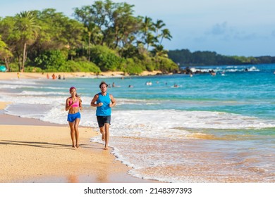 Running Sport Couple Athletes Working Out On Hawaii Beach Doing Cardio Hiit Workout Exercise. Man And Woman Runners Training Together Barefoot On Sand In Waves