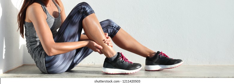 Running sport injury leg pain - runner woman runner hurting holding painful sprained ankle muscle. Female athlete with joint or muscle soreness and problem feeling ache banner panorama. - Shutterstock ID 1211420503