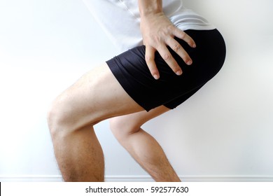 Running sport injury. male athlete jogger wearing man runner massaging hip calf  muscle before workout.healthy care and sport concept.