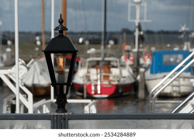 Running street light in front of colorful boats moored in Marken Haven, Amsterdam, Netherlands - Powered by Shutterstock