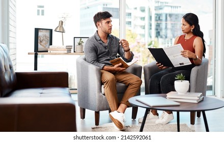 Running Through Their Game Plan From Concept To Completion. Shot Of Two Young Designers Having A Discussion In An Office.