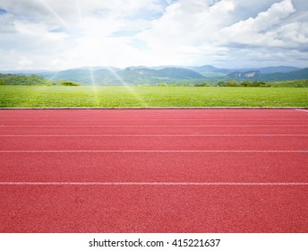 Running Track With Green Grass Background