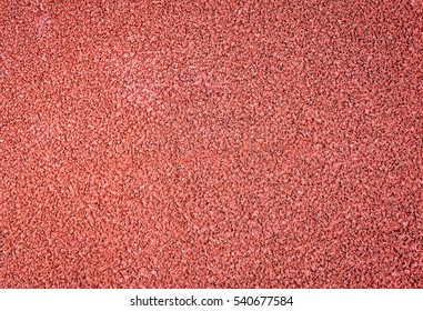 Running track paving surface background. Rubber and fine selected aggregate mix paving, non-slip track and field training ground surface.