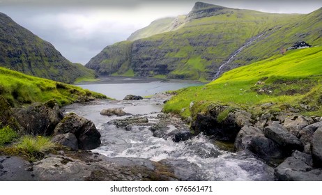 running waterfall between greenery