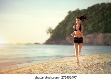 
Running woman, female runner jogging during outdoor workout on beach., fitness model outdoors. - Powered by Shutterstock