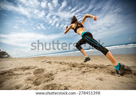 
Running woman, female runner jogging during outdoor workout on beach., fitness model outdoors.