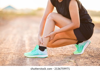 Running Woman Hugging Cramp And Calf Muscle Injury