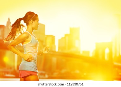 Running Woman. Runner Jogging In Sunny Bright Light. Female Fitness Model Training Outside In New York City With Skyline And Brooklyn Bridge In Background.