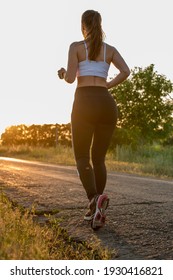 Running Woman. Runner Jogging In Sunny Bright Light. Female Fitness Model Training Outside