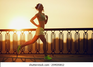 Running Woman. Runner Is Jogging In Sunny Bright Light On Sunrise. Female Fitness Model Training Outside In The City On A Quay. Sport Lifestyle.