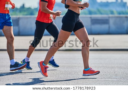 Running women. Sport women jogging in sportswear on city road. Healthy lifestyle, fitness hobby. Street marathon race, sprinting outdoor