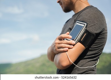 Running Workout Man Listening To Music With Mp3 Player Armband Or Smart Mobile Phone.