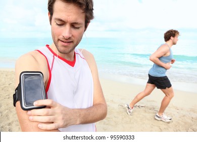 Running Workout Man With Mp3 Music Player Listening To Music With Mp3 Player Armband Or Smart Mobile Phone.