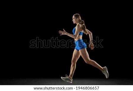 Similar – One young middle age athletic, woman training, exercising with fitness jumping rope over dark background, full length front view, looking at camera