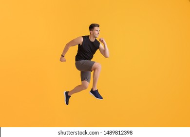 Running Young Man On Color Background