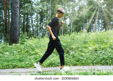 Running Young Man, Teenager. Running Teen Jogging In The Park. Guy Workout Outdoors. Training On A Forest Trail. Healthy, Fitness, Wellness Lifestyle. Sport, Cardio, Workout Concept