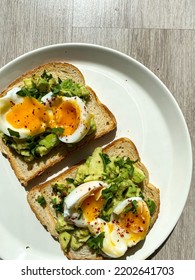 Runny Egg Yolk On Avocado Toast For Breakfast