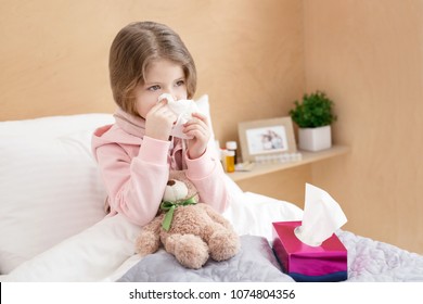 Runny Nose. Little Sick Girl Lying In Bed And Blowing Her Nose