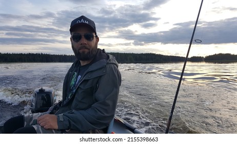 RUOVESI, FINLAND: JULY 20, 2019: Fishing. Happy Smiling Fisherman On A Pontoon Boat. Amazing Fishing Spot In Finland