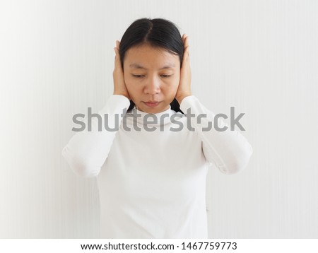 ruptured eardrum,tinnitus and meniere disease and otitis media in asian woman. She use hand touching her ear causes of ear pain on white background use for health care concept. Foto stock © 