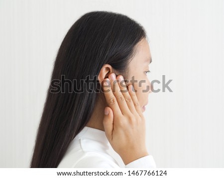 ruptured eardrum,tinnitus and meniere disease and otitis media in asian woman. She use hand touching her ear causes of ear pain on white background use for health care concept. Foto stock © 