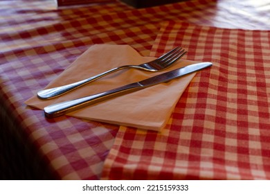 Rural Cover With Fork And Knife On A Table With Red Checkered Cloth