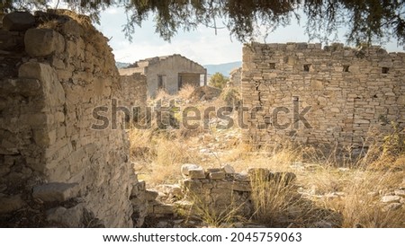 Rural depopulation. Overgrown ruins of abandoned traditional village in Cyprus