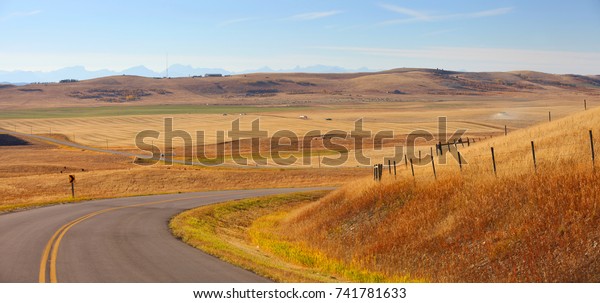Rural drive\
through prairies in Alberta, Canada\
